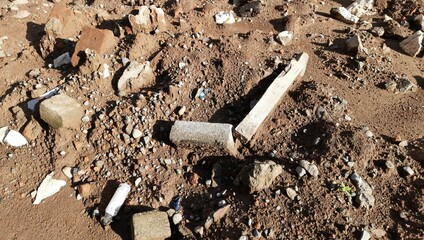 The rubble of a building is scattered on a pile of soil