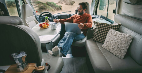 One alone man sitting and relaxing inside a camper van alternative home vanlife lifestyle off grid...