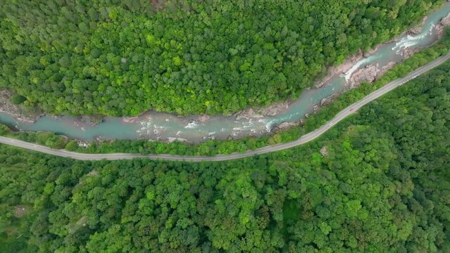 Aerial view of Mountain river and road. Flying over a mountain gorge