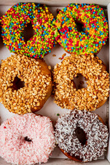 Sweet delicious glazed donuts in box, closeup