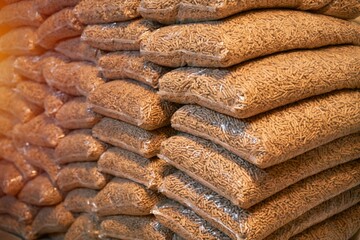 A massive stack of wooden pellets. Eco fuel for house heating. Sustainable and renewable energy for the better future concept.