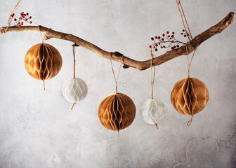 Handmade paper Honeycomb balls hanging on tree branch. Beautiful Christmas decoration foe home. Scandinavian Nordic Craft Paper concept. Selective focus. Copy space.