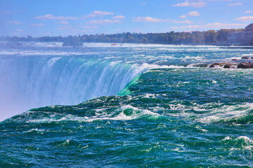 Right on edge of Niagara Fall's Horseshoe Falls with turquoise waters in Canada