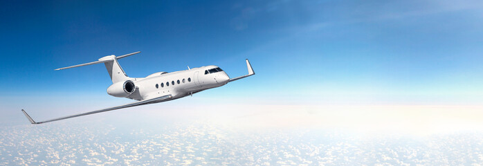 A business plane flying at high altitude above the clouds