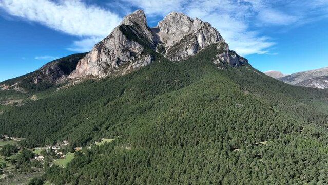 Majestic Pedracorca dense woodland Pyrenees mountain landscape aerial view flying towards summit