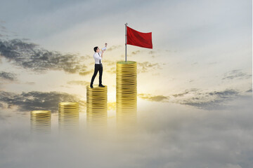 Asian businessman with a megaphone standing on coin stairs