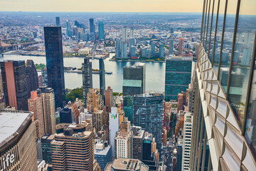 Edge high up of skyscraper wall overlooking New York City Manhattan skyline from above
