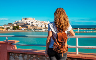 Fototapeta premium Woman tourist looking at Peniscola city landscape, Castellon in Spain