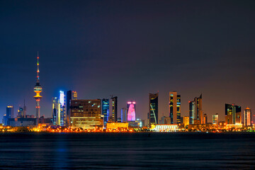 Obraz na płótnie Canvas View of the Kuwait skyline - with the best known landmark of Kuwait City - during Night. Kuwait City buildings and skyline from beach at night..