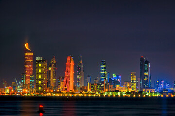 Fototapeta na wymiar View of the Kuwait skyline - with the best known landmark of Kuwait City - during Night. Kuwait City buildings and skyline from beach at night..