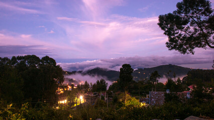 South Indian hill station aerial view and covered with fog during the evening time with trees and plants around it. Kodaikanal hiils station tourist spot. Tamilnadu hills and tourism .