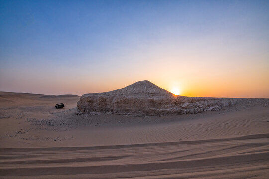 Sun is rising in the desert . Sunrise-sunset desert landscape photo. Gulf desert sunrise with sand dunes and sand pattern visible with sun shine. .