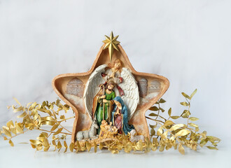 Traditional christmas native scene and decorations on abstract light background. Star of Bethlehem, symbol of Christmas, Advent holiday. festive winter season © Ju_see