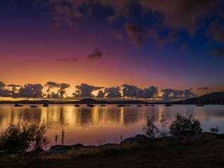 Aerial sunrise waterscape with boats, clouds and reflections