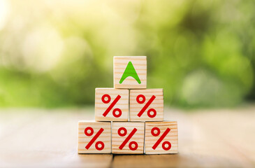 Interest rate financial and mortgage rates concept. Wooden blocks are lined up in steps with up arrow and interest symbols. Mortgage rates business concept of investment,  interest rates appraisal.