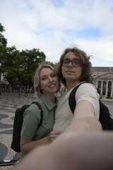 Smiling tourist couple taking selfie. Man and woman looking at camera with joy. Portrait, travelling concept