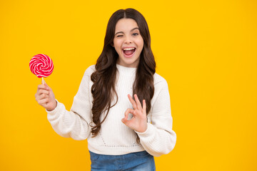 Excited teenager girl with caramel candies on sticks, sweet sugar addiction. Child with lollipops.