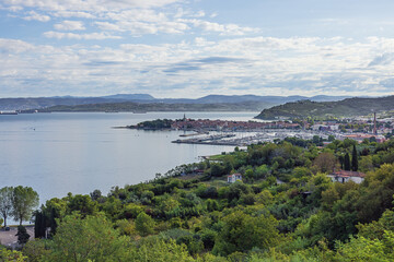 Fototapeta na wymiar Overview of Izola and its coastline with ships awaiting to enter Koper harbor