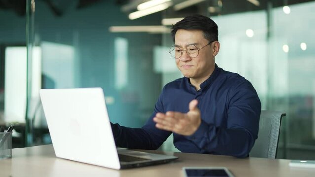 Busy IT programmer with glasses feels annoyed has problem with laptop computer in modern office Businessman angry because system error data loss backup battery issues bag virus mistake in code indoor