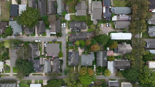 Top down aerial of homes in Deep South USA. Southern United States rooftop view. Aerial truck shot.