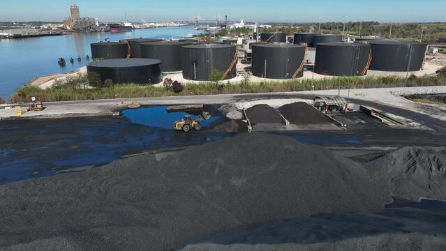 Coal and fuel tankers at port in Mobile Alabama ready for shipment in Gulf Coast region. Aerial view.