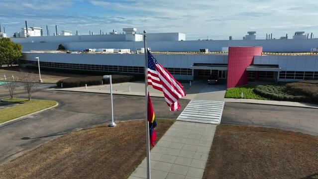 USA and Mississippi flags at large manufacturing plant in Canton MS. American manufacturing theme. American made goods.