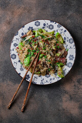 Fried rice with vegetables and beef on the plate