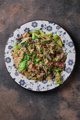 Fried rice with vegetables and beef on the plate