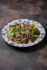 Fried rice with vegetables and beef on the plate