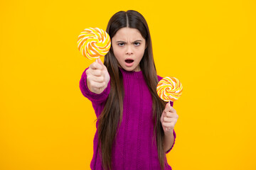 Hipster teenager child girl lick lollypop. Sugar nutrition, candy and sweets. Child eat lollipop...
