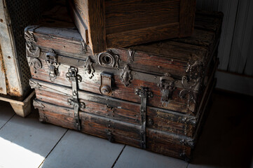 Old wooden trunk or chest with metal fittings in an old wild west house