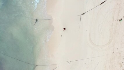 aerial top down of young man running on empty white sand beach in Playa Del Carmen Mexico - Powered by Adobe