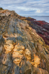 Beautiful patch of Maine coast with layers of rocks and mineral veins