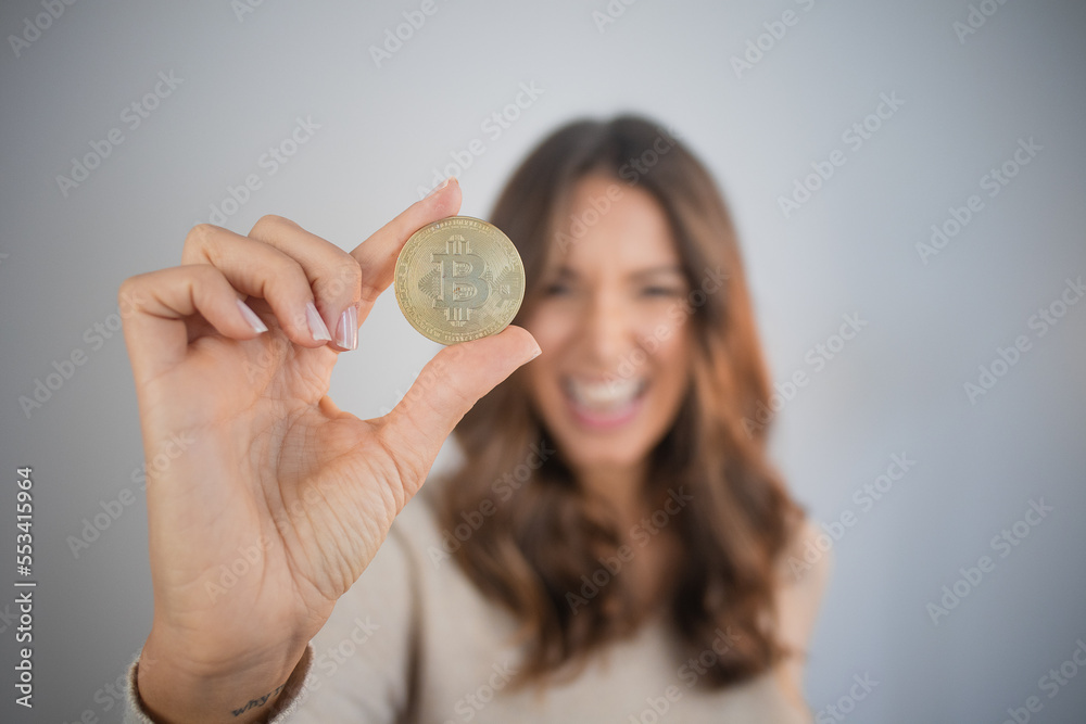 Wall mural happy person holding bitcoin investment cryptocurrency