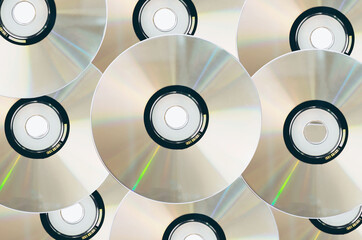Many old CDs represent technology from the 90s. Stacks of CDs, old songs and old movies. which had...