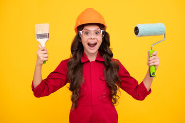 Excited teenager girl. Building, construction and profession concept - smiling little girl in protective helmet and safety vest with paint roller.