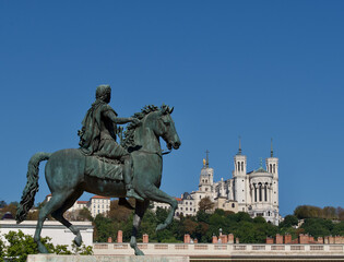 Statue of King Louis the 14th looking at the Fourvi&egrave;re hill on which the Notre Dame de Fourvi&egrave;re basilica is placed in Lyon, France