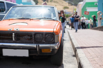 an old rusty sports car on the street of Cape town