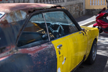 an old rusty sports car on the street of Cape town