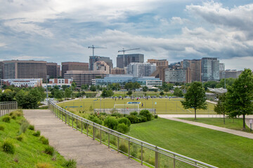 Walkway in urban park and skyline of Arlington, Virginia, USA