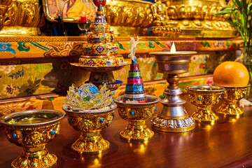 Ornate gold cups in Tibetan Mongolian Buddhist shrine