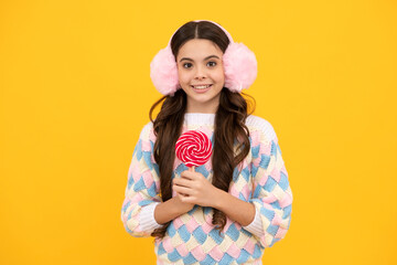 Teenage girl with candy lollipop, happy child 12, 13, 14 years old eating big sugar lollipop, sweets candy.