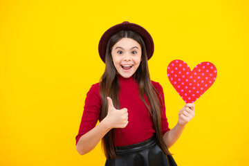 Happiness kids and love concept. Romantic lovely teen girl with red heart, world heart day, happy valentines day. Excited teenager, glad amazed and overjoyed emotions.