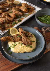 Sesame chicken drumsticks marinated with harissa sauce and topped sesame seeds. Served ready to eat on kitchen table