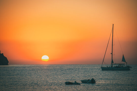 Orange Sunset Above Sea With Boat Amazing Golden Reflection Of The Sun On The Calm Waves. Summer Landscape With Sun And Sea In Turkey