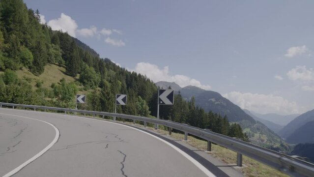 Driving a car on the Gotthard Pass from South to North Switzerland. Amazing Views of the swiss alps and the mountains from the Cars point of view. Famous Gotthardpass or Passo del San Gottardo.