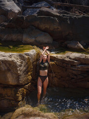 Turkey travel, mediterranean area on a warm summer day. Young woman in swimsuit have fun in mountain river. Concept of living open air, Travel , active lifestyle, summer vacation.