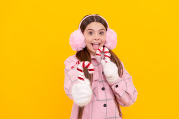 express positive emotion. winter fashion. christmas holiday. surprised kid in fur earmuffs