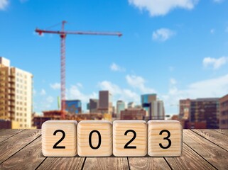 Set of wooden cubes blocks with 2023 on the desk