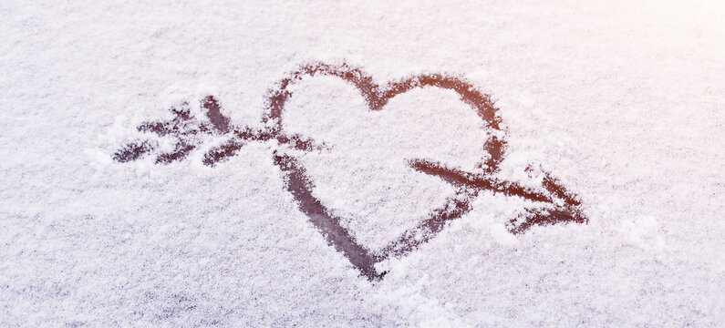 heart in the snow with an arrow